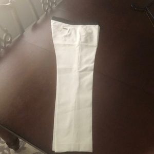 Skinny white Michael Kors capris with black top.